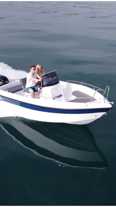 A motorboat cruising on calm Ionian waters